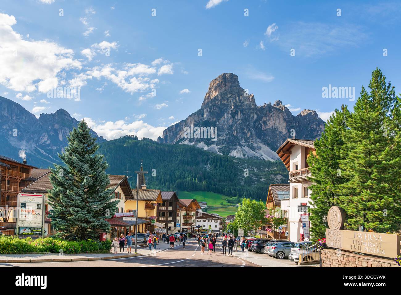 CORVARA IN BADIA, SÜDTIROL - ITALIEN - 24. JULI 2025 Blick auf die Hauptstraße von Corvara in Badia, Alta Badia. Alpenländische Architektur mit Touristen und t Stockfoto