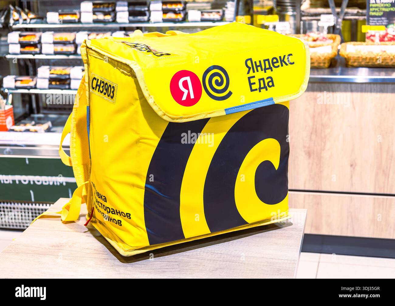 Samara, Russland – 5. April 2025: Yandex-Thermobeutel für Lebensmittel. Text auf russisch auf einem Beutel: Yandex Food. Fast Food-Lieferung Stockfoto