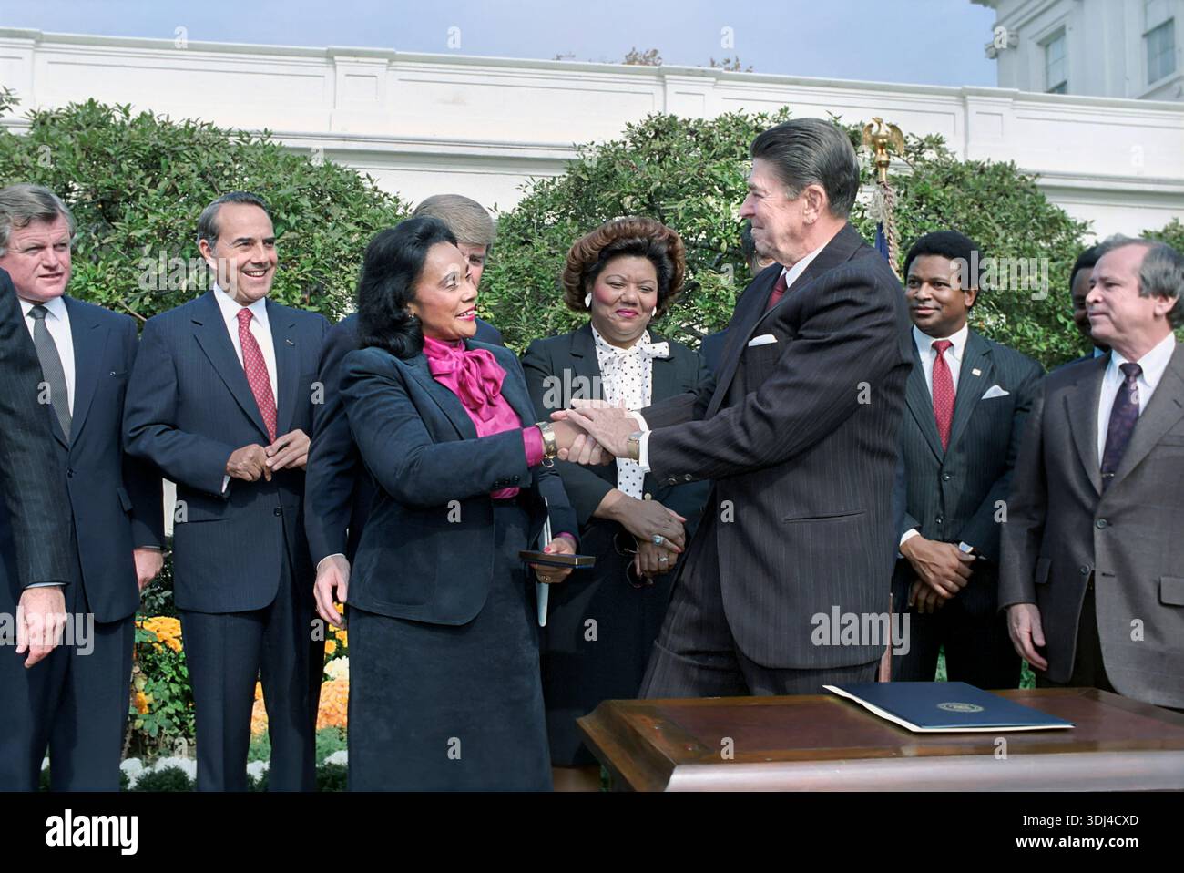 US-Präsident Ronald Reagan schüttelt die Hand mit Coretta Scott King bei der Unterzeichnungszeremonie für HR 3706 zum Geburtstag von Martin Luther King Jr. Ein Nationalfeiertag mit Howard Baker, Bob Dole, Katie Hall und Edward Kennedy, White House Rose Garden, Washington, D.C., USA, Präsident Ronald Reagan White House Photographic Office, 2. November 1983 Stockfoto