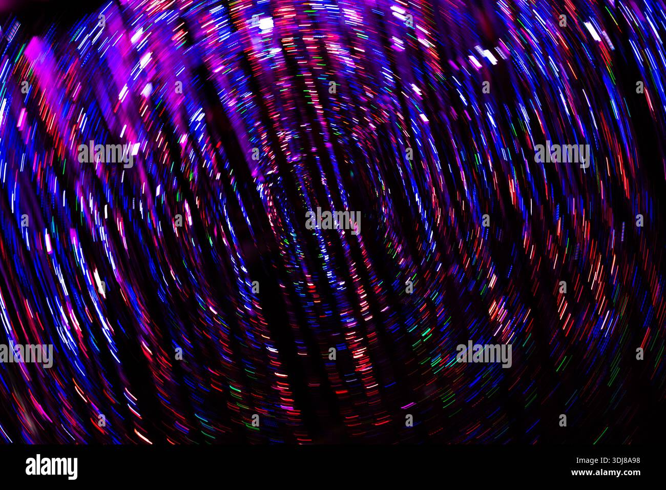 Farbenfroher psychedelischer Hintergrund mit bunten Lichtern oder Glitzer, der sich in einer kreisförmigen Wirbelbewegung dreht Stockfoto