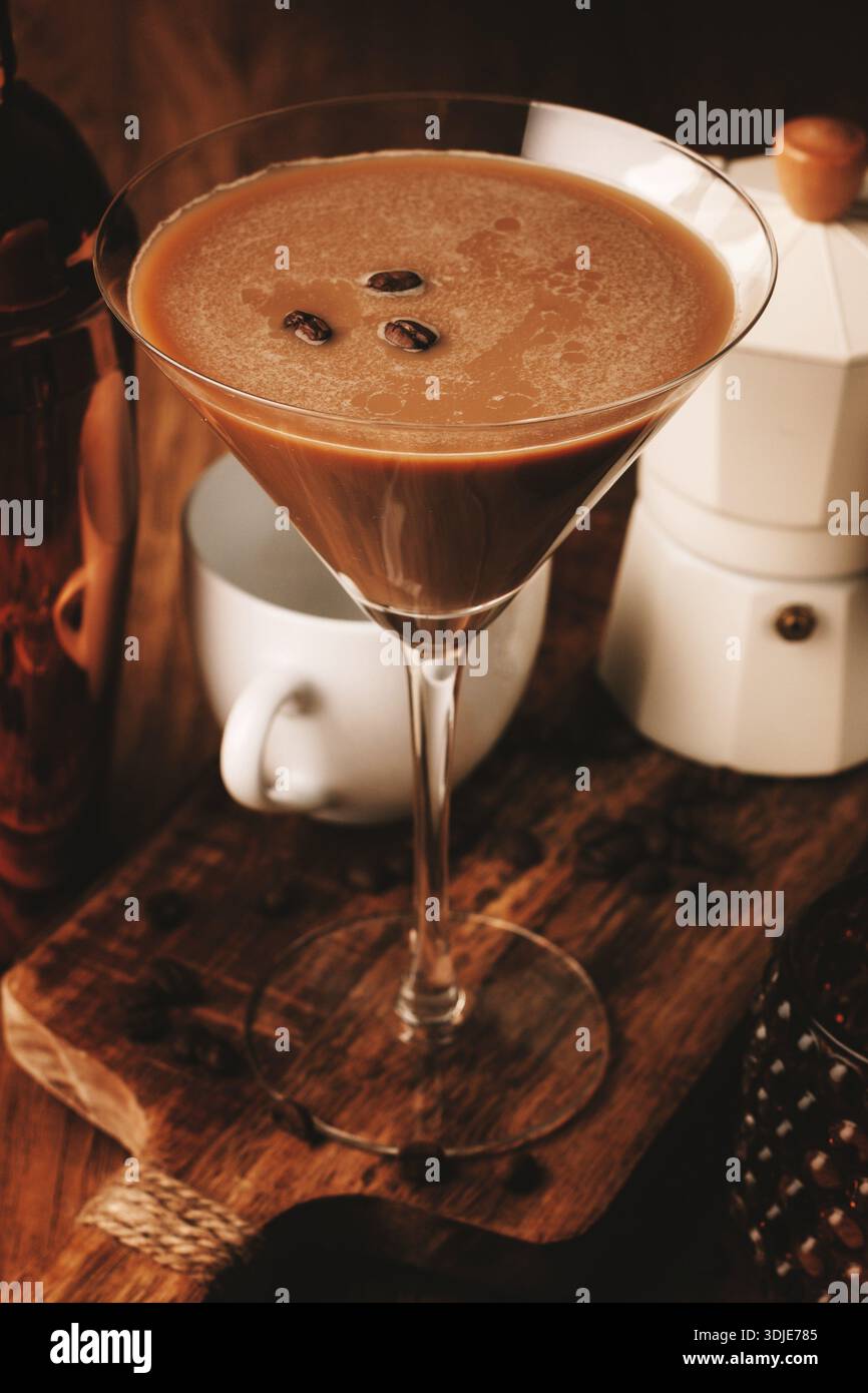 Espresso-Martini-Cocktail, alkoholisches Getränk, Shaker und Geysir-Kaffeemaschine, auf hölzernem Hintergrund Stockfoto