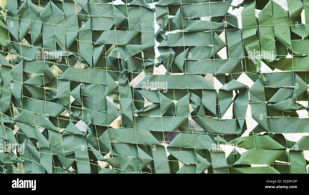 Grünes Tarnnetz, das Verbergen und Schutz mit militärischer Textur schafft Stockfoto
