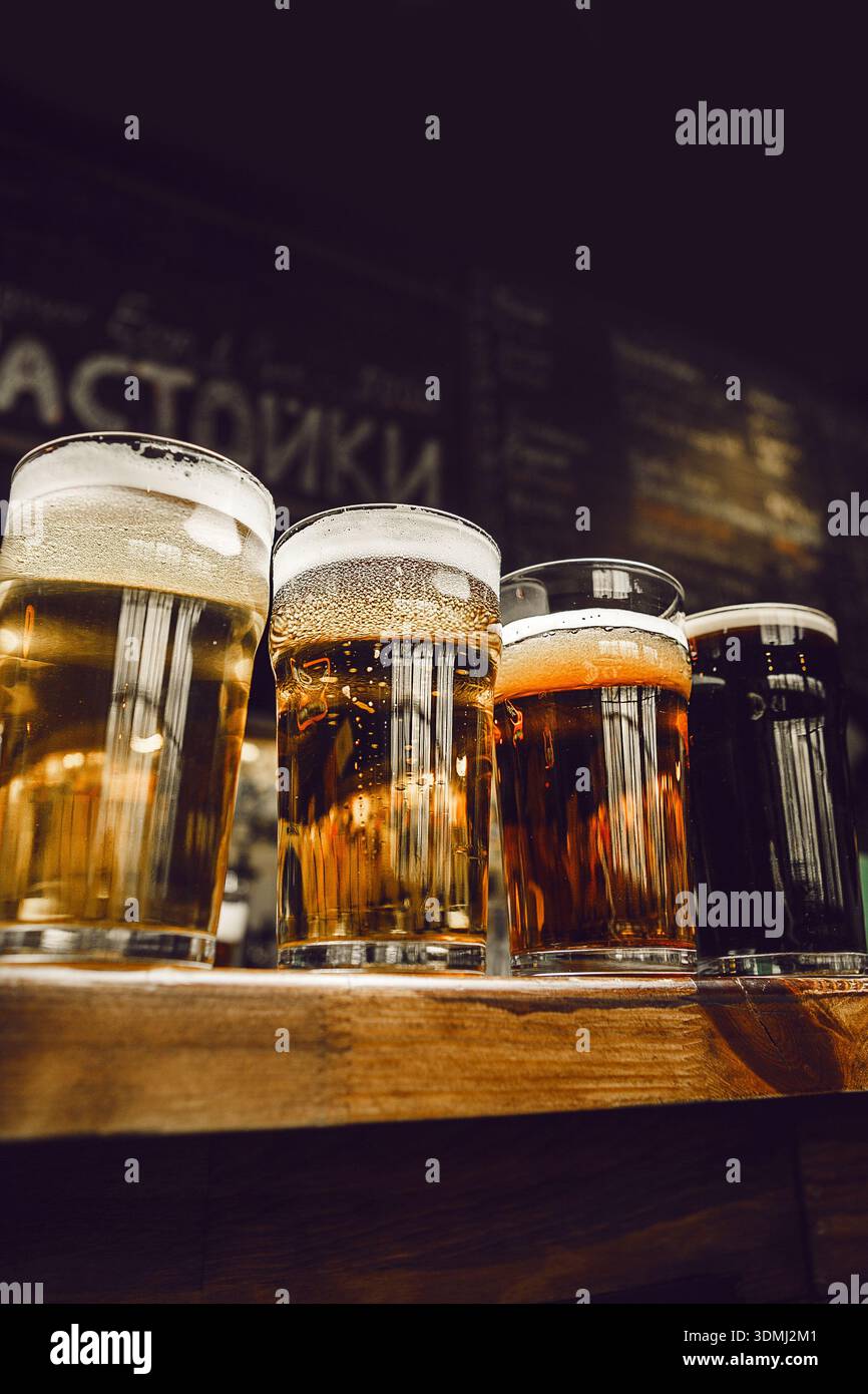 Nahansicht verschiedener Biergläser an Holztheke Stockfoto