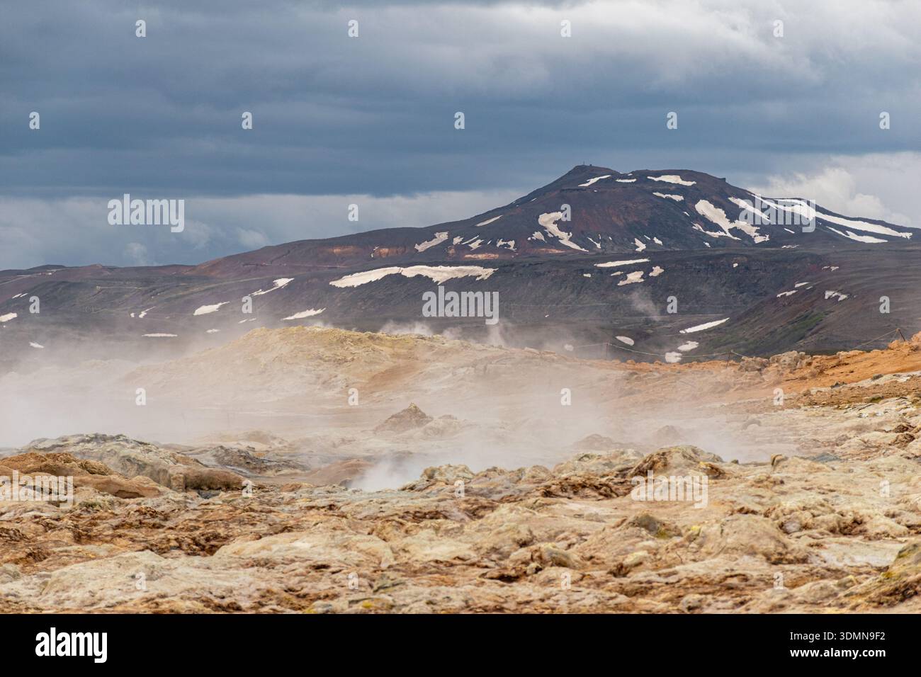 Heiße Quellen im geothermischen Gebiet von Hverir-Namafjall mit dem Krafla-Vulkan im Hintergrund im Norden Islands Stockfoto