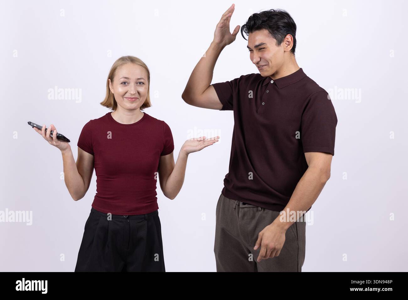 Junger Mann und Frau, die im Studio mit Händen gespendet haben Stockfoto