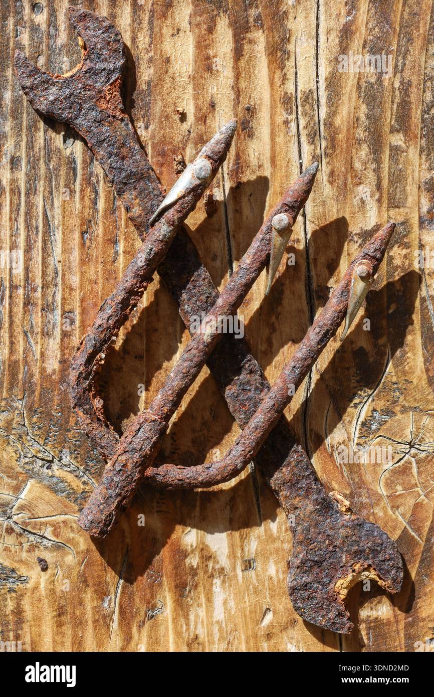 Zwei korrodierte Werkzeuge bilden eine stille Aussage über vergessene Geschäfte und die Erosion der menschlichen Industrie. Stockfoto