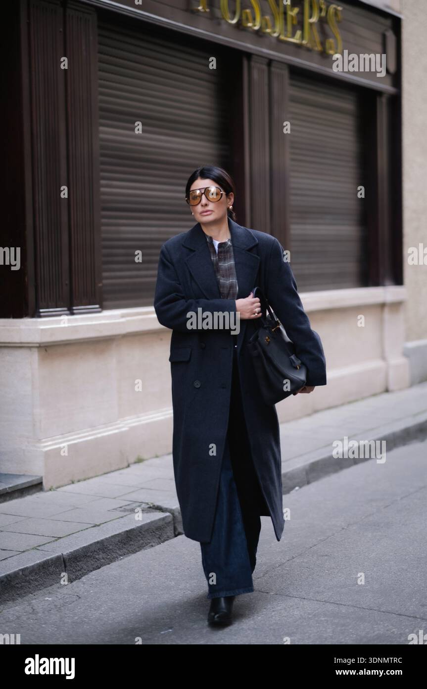 MÜNCHEN - 14. OKTOBER 2025: Sofiya Balci in einem Kohlemantel und kariertem Hemd während eines Street-Style-Shootings in München. Stockfoto