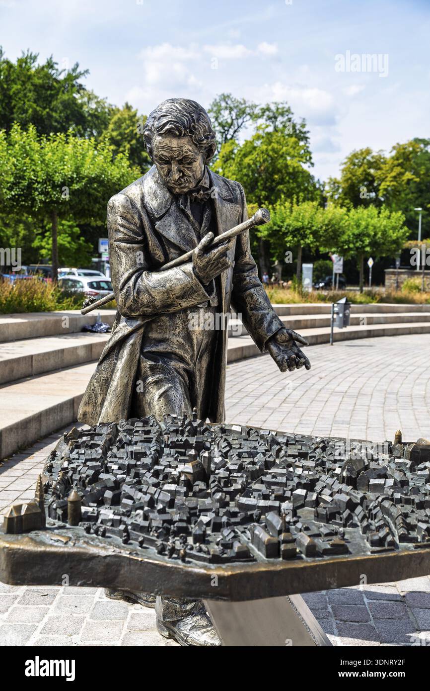 Silberfiguren-Entdecker, der mit Ekaterina Kovalenko auf dem Schlossplatz mit Bronzemodell der Altstadt unterwegs ist, machen Sie Halt auf dem Siberweg-Abenteuerweg Stockfoto
