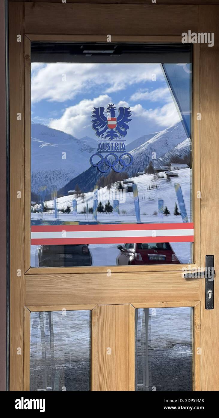 Livigno, Italien - 12. Februar 2026: Logo der Olympischen Nationalmannschaft Österreich mit Nationaladleremblem auf dem Fenster im verschneiten Bergdorf während des Mailand-Cor Stockfoto