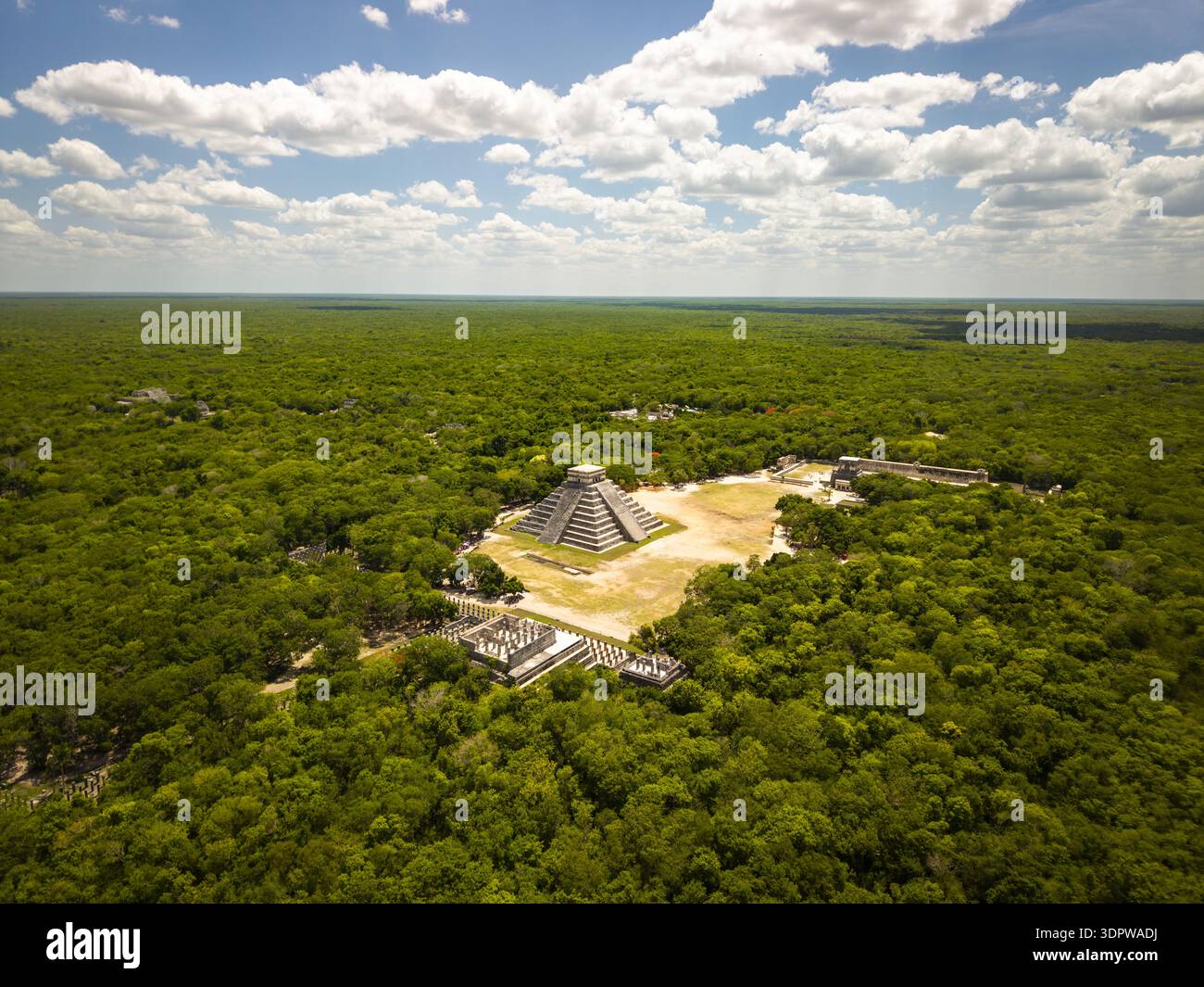 Blick aus der Vogelperspektive auf die alte Maya-Architektur inmitten eines lebendigen grünen Dschungeldaches, dominiert von der imposanten Pyramide von Kukulcán, Chichén-Itzá, Yucatan und mir Stockfoto