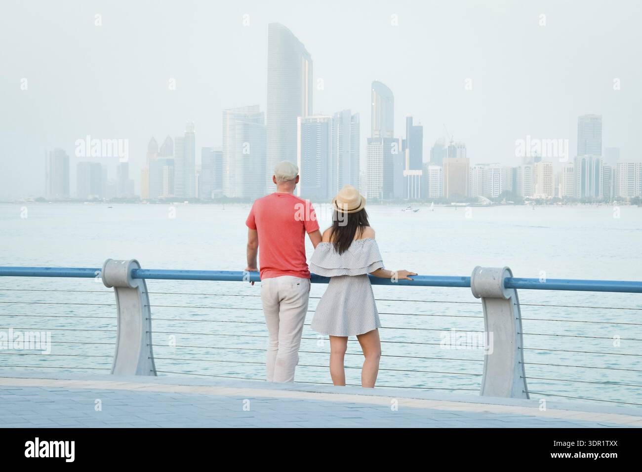 Kaukasische Touristen romantische Paare stehen zusammen und genießen das Panorama der Skyline auf dem malerischen Aussichtspunkt in Abu dhabi. Besuchen Sie die Reise Sightseeing VAE Concept Stockfoto