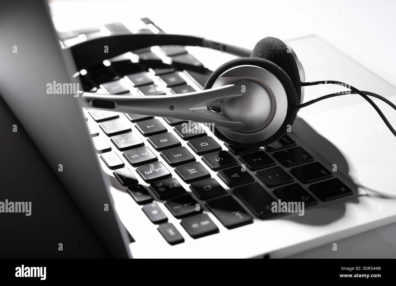 Kopfhörer auf der Tastatur des Laptops Stockfoto