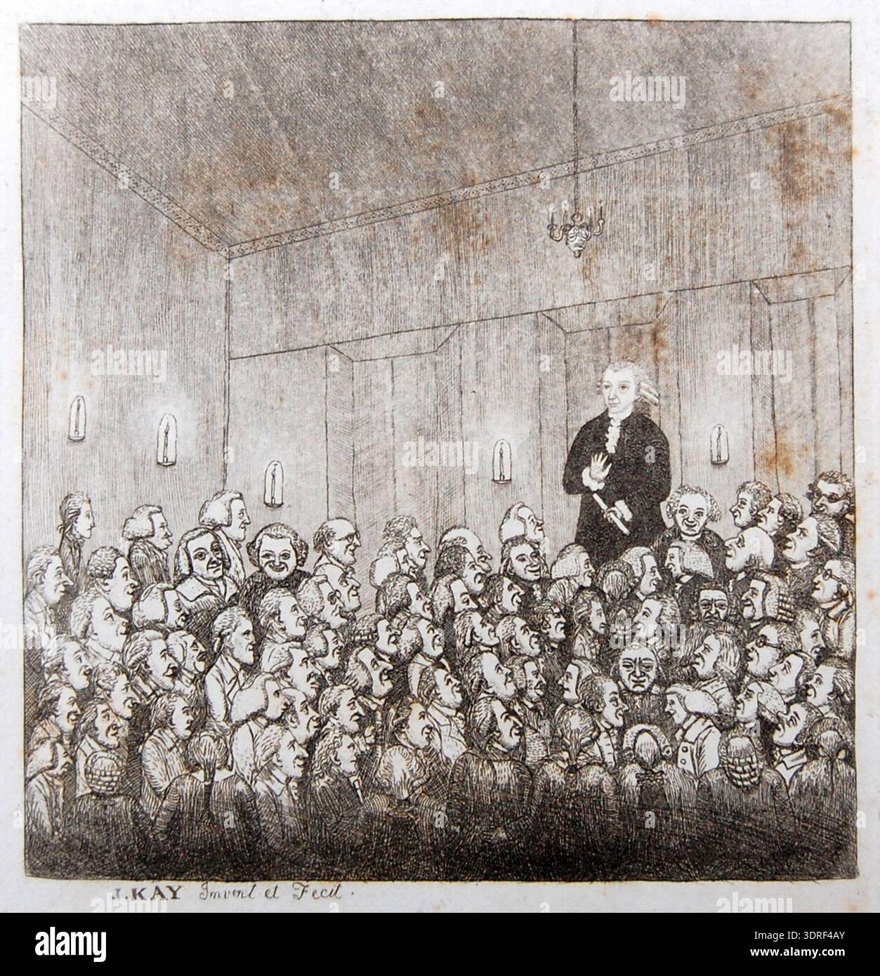 Diese Radierung mit Aquatint von John Kay aus dem Jahr 1785 zeigt Dr. Graham, der vor einem rein männlichen Publikum in Edinburgh vorträgt. Graham steht über und hinter der Menge und hält ein gerolltes Dokument. Der Raum wird von einem kleinen Hängeleuchter mit vier Kerzen und Wandlampen mit einzelnen Kerzen beleuchtet. Die Ausdrucksformen des Publikums variieren, manche schauen nach oben, andere wenden sich ab, viele grinsen. Vordergrundfiguren sind halblang auf einer Bank sitzend. Der Druck zeigt die schottischen Vorlesungen aus dem 18. Jahrhundert, Kostüme, Gesichtsausdrücke und Details im Innenraum. Stockfoto