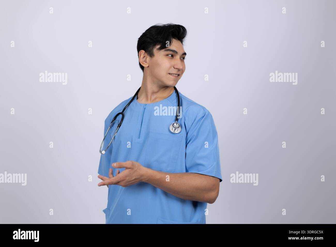 Männlicher Doktor in blauen Peelings, der zur Seite gestickt hat Stockfoto