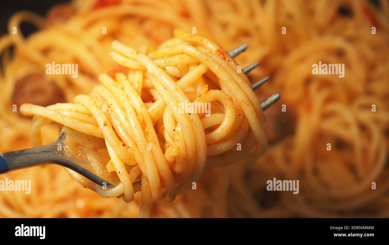 Gekochte Spaghetti auf einer Gabel mit Sauce und Fleischbällchen Stockfoto