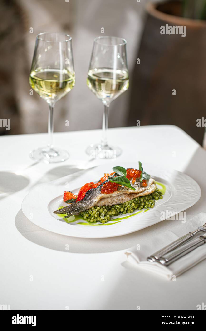 Gebratener Fisch mit Kaviar und grünen Erbsen Stockfoto