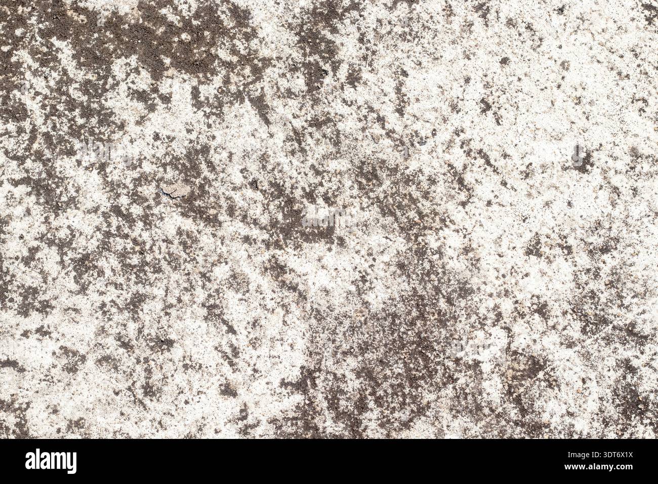Rauer grauer, strukturierter Hintergrund, der an verwitterten Zement erinnert, mit diagonalen Kratzmustern, granularen Oberflächendetails, unebenen Tönen und robusten Steinen Stockfoto