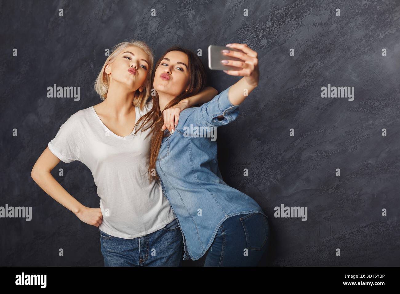 Freunde machen ein Selfie in einem Studio-Set während eines zwanglosen Moments am Abend Stockfoto