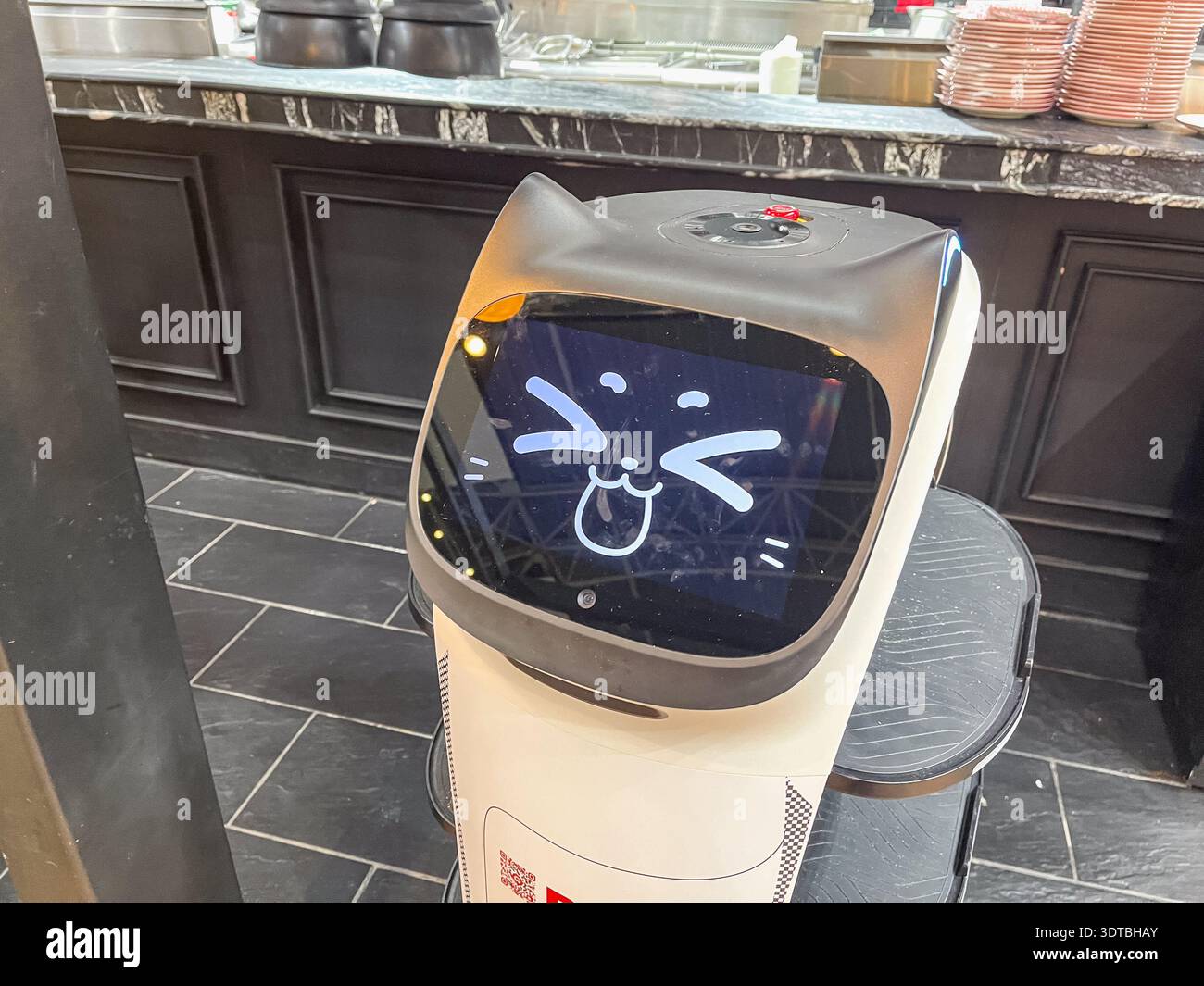 10. Februar 2026, Istanbul, Türkei: Nahaufnahme intelligenter Roboter-Gesichtsbildschirm mit animiertem Katzenemoticon zur Kundenbindung in Restaurants für Branding Stockfoto