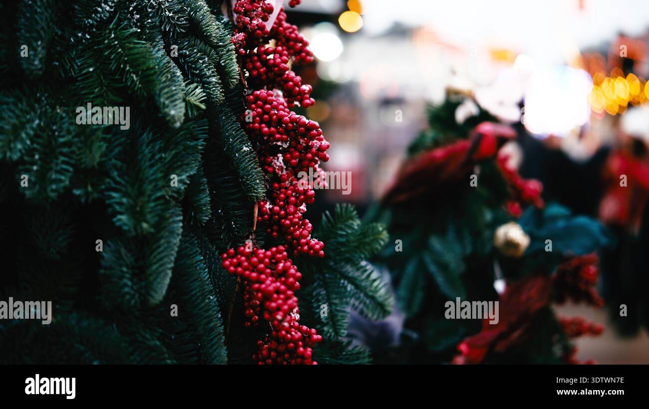 Weihnachtsbaum dekoriert mit roten Beeren auf Einem Weihnachtsmarkt auf der Weihnachtsmesse Stockfoto