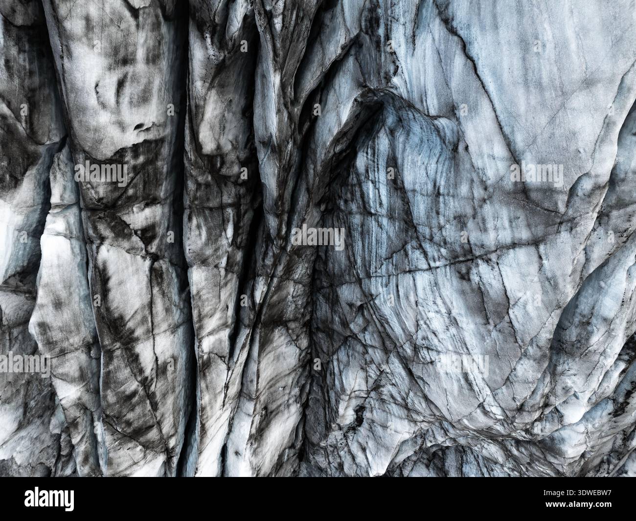 Komplizierte Eismuster auf dem Skaftafell-Gletscher in Island zeigen die faszinierende Textur und natürliche Kunstfertigkeit, die durch Schichten von Eis, Felsen und se gebildet werden Stockfoto