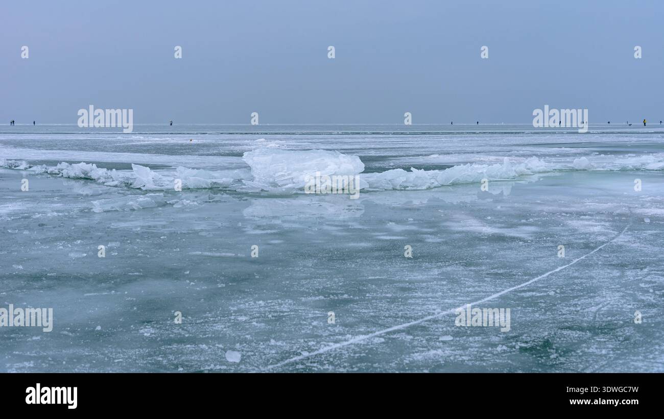 Eis, das sich im Winter aus Rissen an der Oberfläche eines gefrorenen Balatons in Ungarn angesammelt hat Stockfoto