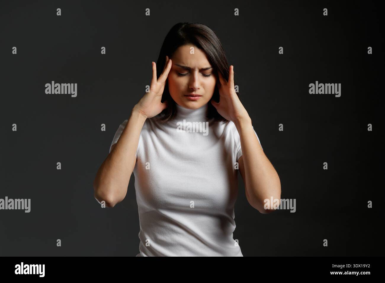 Junge Frau mit starken Kopfschmerzen oder Migräne Stockfoto