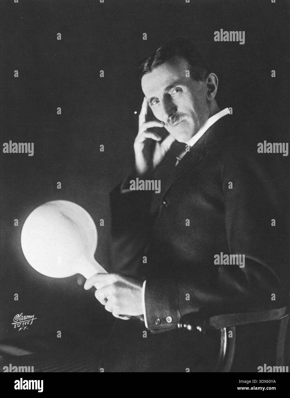 Eine weitere Erfahrung. Tesla trägt eine Lampe einige Meter vom Generator entfernt, aber sie leuchtet immer noch! Stockfoto