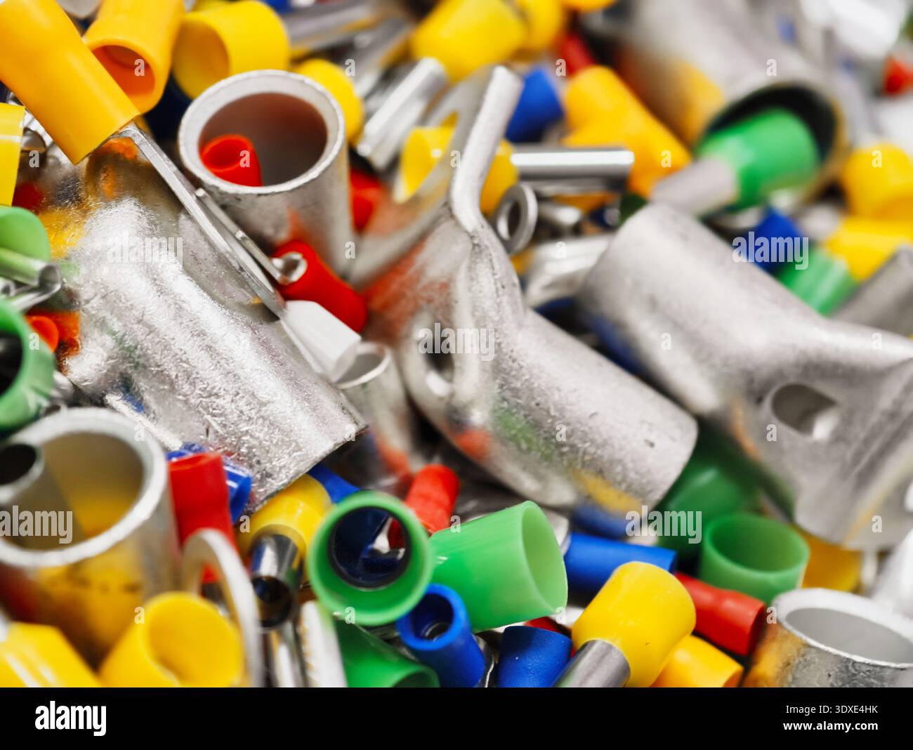 Buntes Sortiment an elektrischen Steckverbindern und Stromkabeln in einer lebendigen Werkstatt Stockfoto