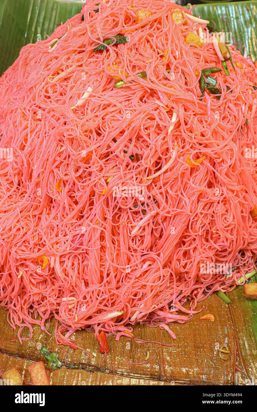 Thailändische rosa gebratene Nudeln mit Yentafo-Sauce auf Bananenblatt, lebendiges Street Food und authentisches südostasiatisches Konzept. Stockfoto