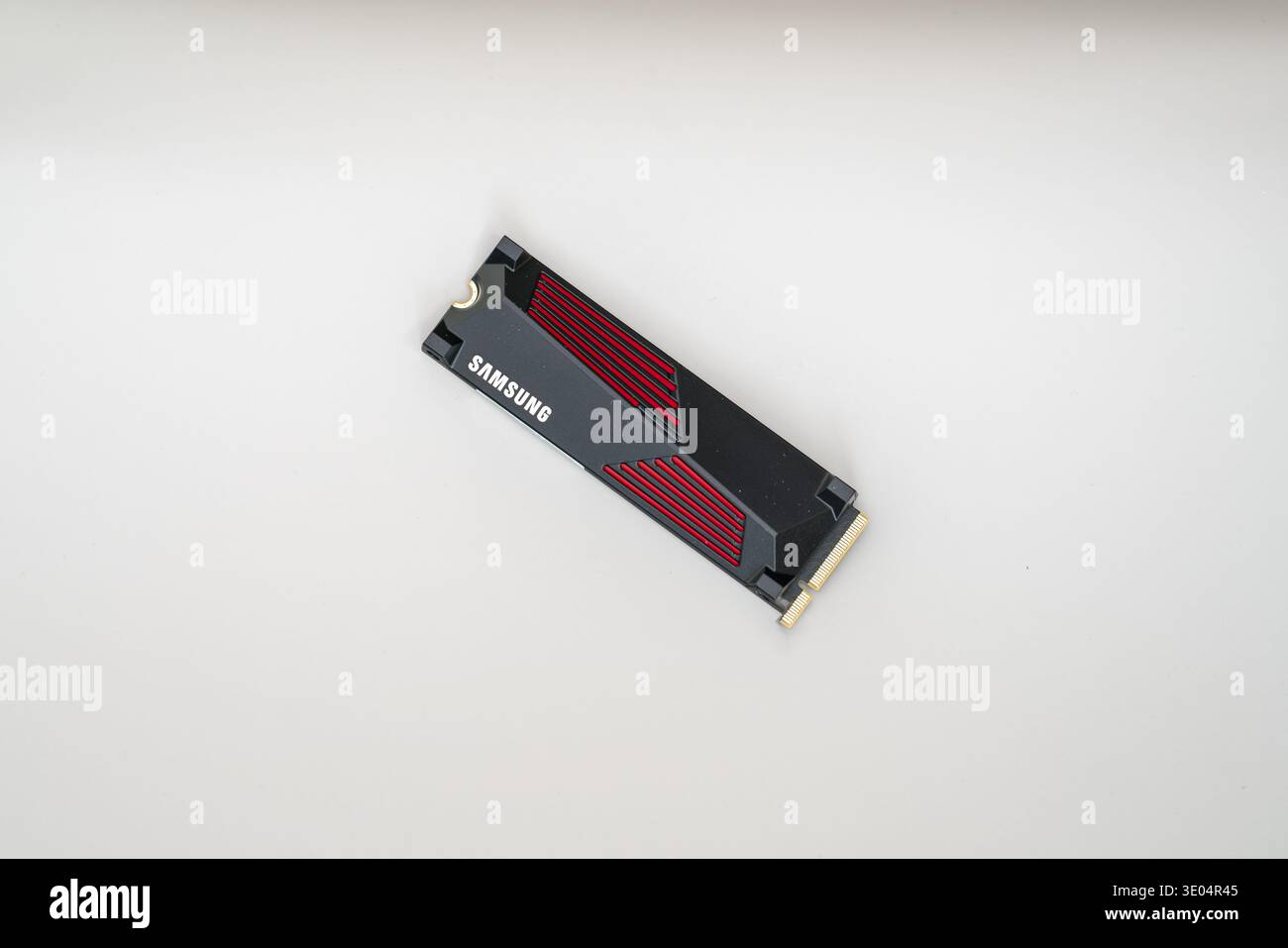 Nahaufnahme eines Samsung NVMe Solid-State-Laufwerks mit roten Akzenten, isoliert auf weißer Oberfläche für technische Produktfotografie Stockfoto