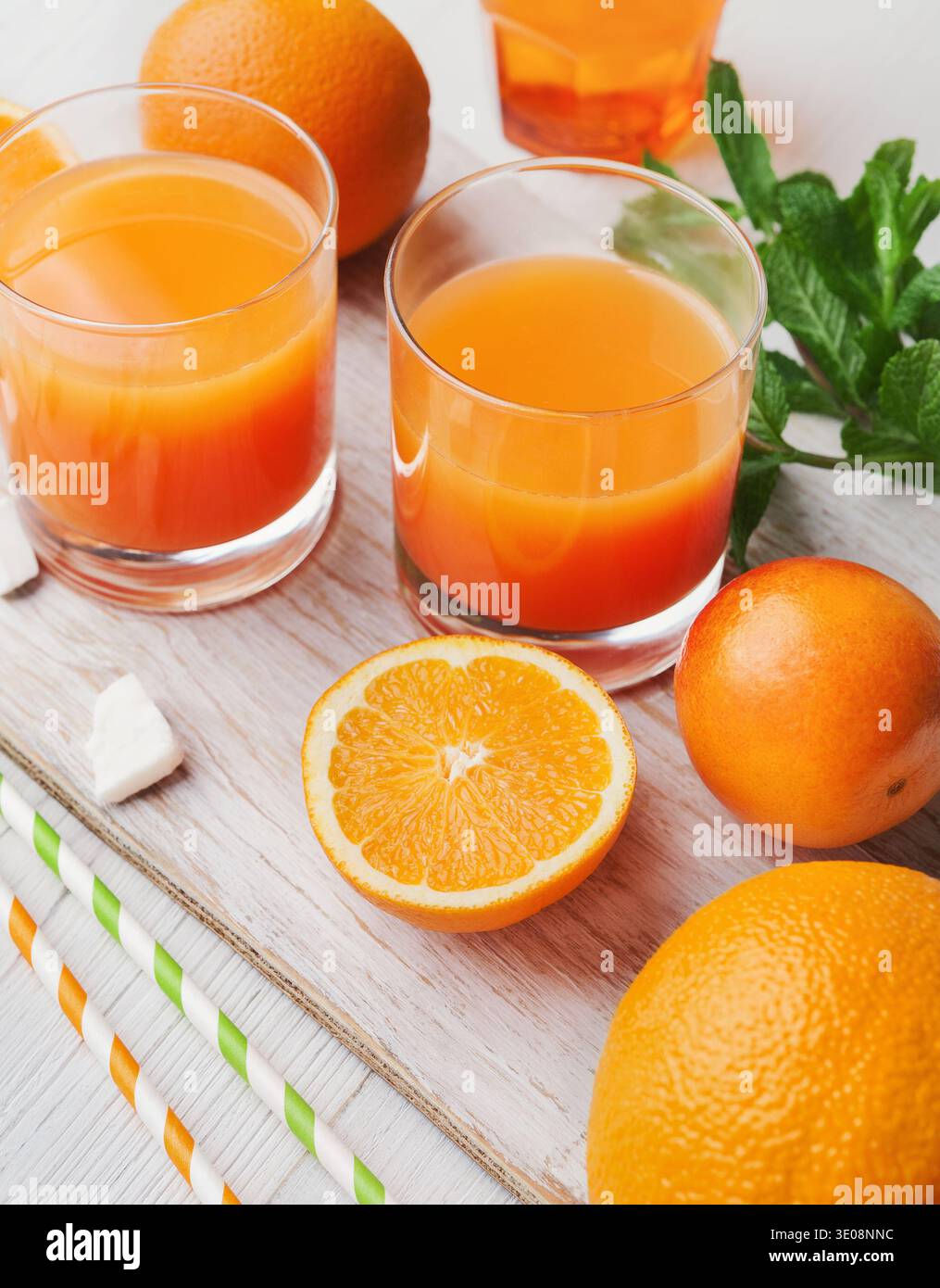 Frischer Orangensaft mit Obst auf Holztisch Stockfoto