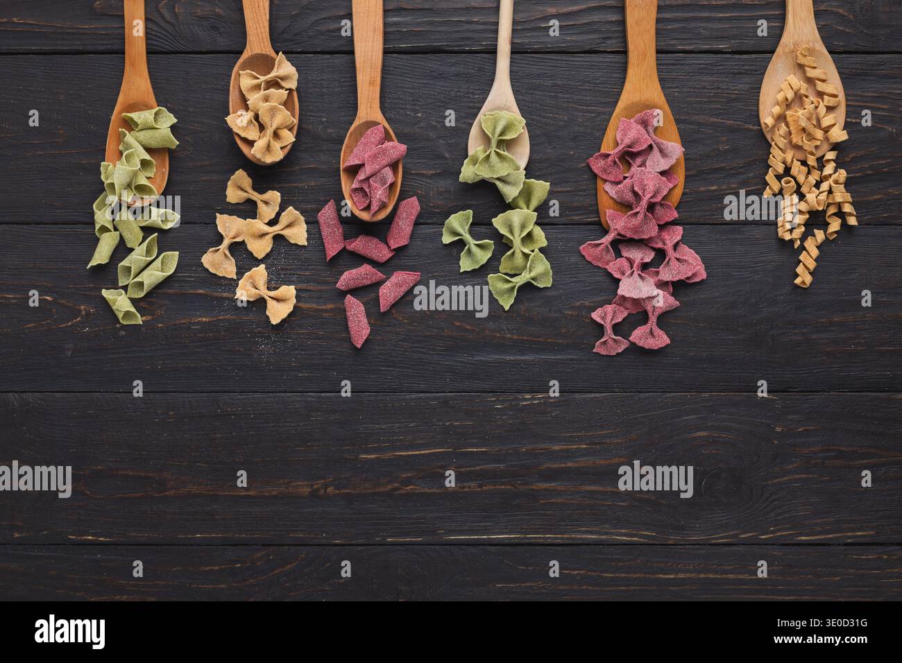 Bunte Pasta auf Holztisch, Blick von oben Stockfoto