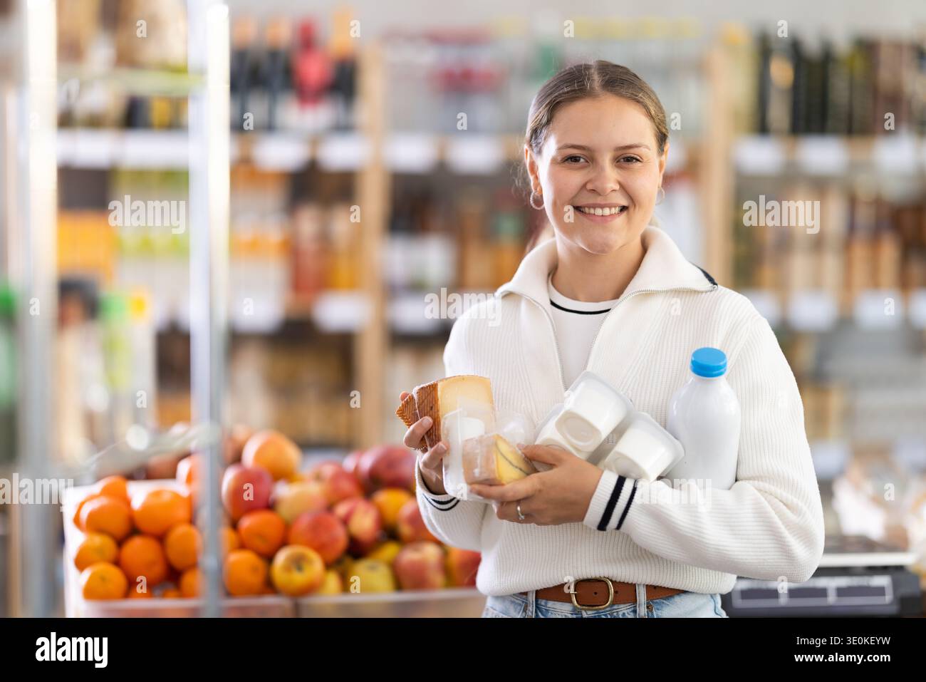 Frau wählt Milchprodukte Stockfoto