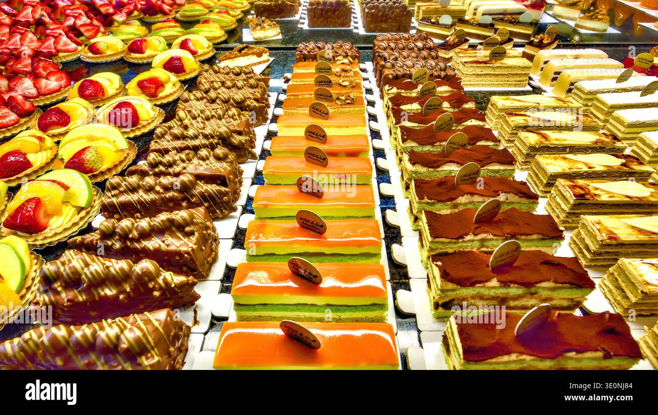 Ausstellung von schick dekorierten Schokoladen- und Obstkuchen-Scheiben in der Bäckerei Saint-Gilles, Brüssel, Belgien. Stockfoto