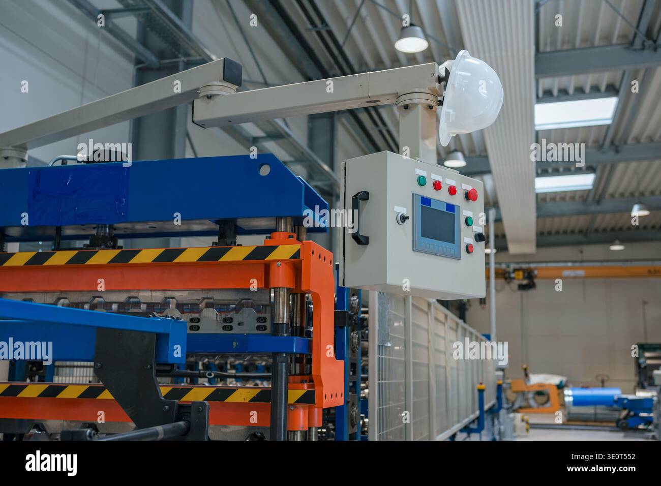 Die automatisierte Produktionslinie innerhalb eines Fertigungswerks zeigt verschiedene Industriemaschinen und -Anlagen, die ohne Arbeitskräfte arbeiten. Stockfoto
