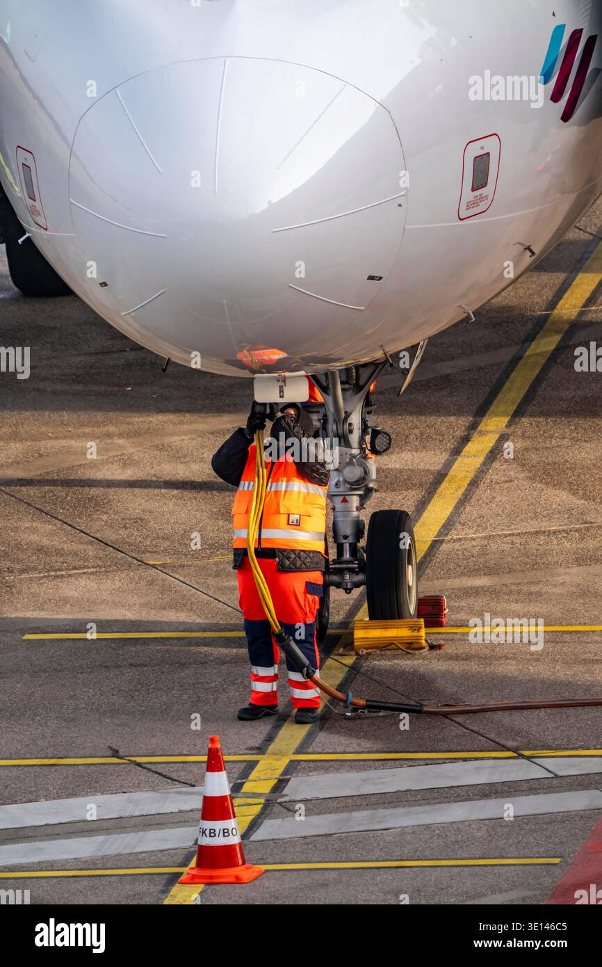 Die Bodenbesatzung installiert das Bodenaggregat, die Stromversorgung für das Flugzeug, nachdem sie an der Parkposition, am Terminal, am Gate, am Passplatz angehalten hat Stockfoto
