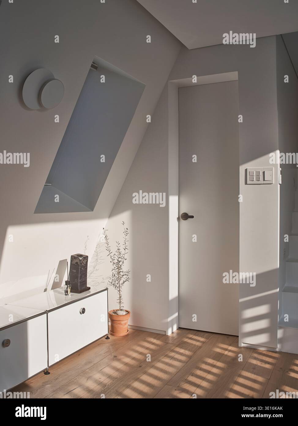 Minimalistische Küche mit Insel und helles Nachmittagslicht. Stockfoto