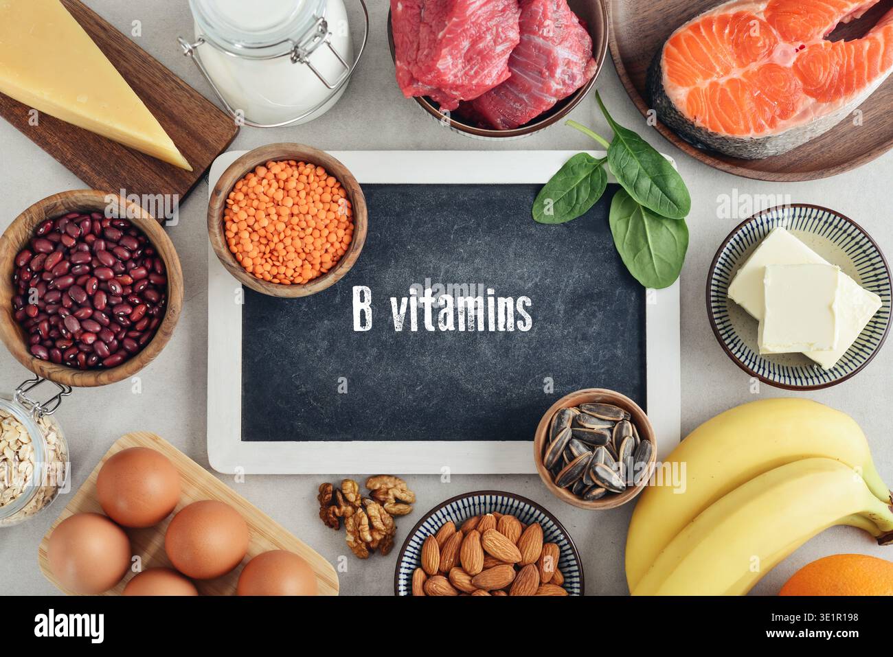 Gesunde Lebensmittel, die Vitaminum B-Komplex enthalten. Natürliche Vitamin-B-Quellen auf hellem Hintergrund mit Tafel, Draufsicht. Stockfoto