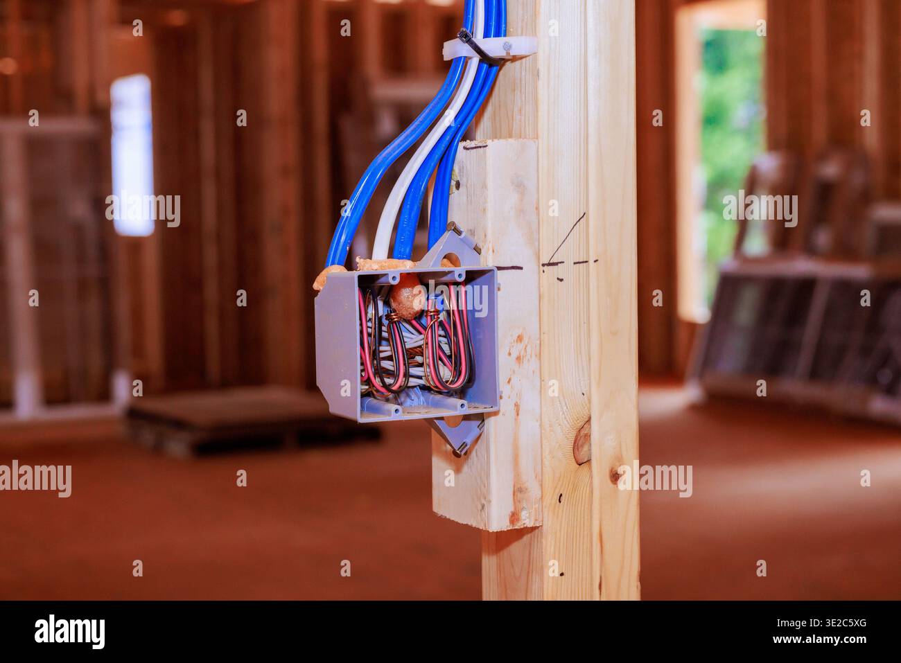 Verdrahtungskasten auf Holzpfosten im Gebäude im Bau mit Werkzeugrequipment Stockfoto