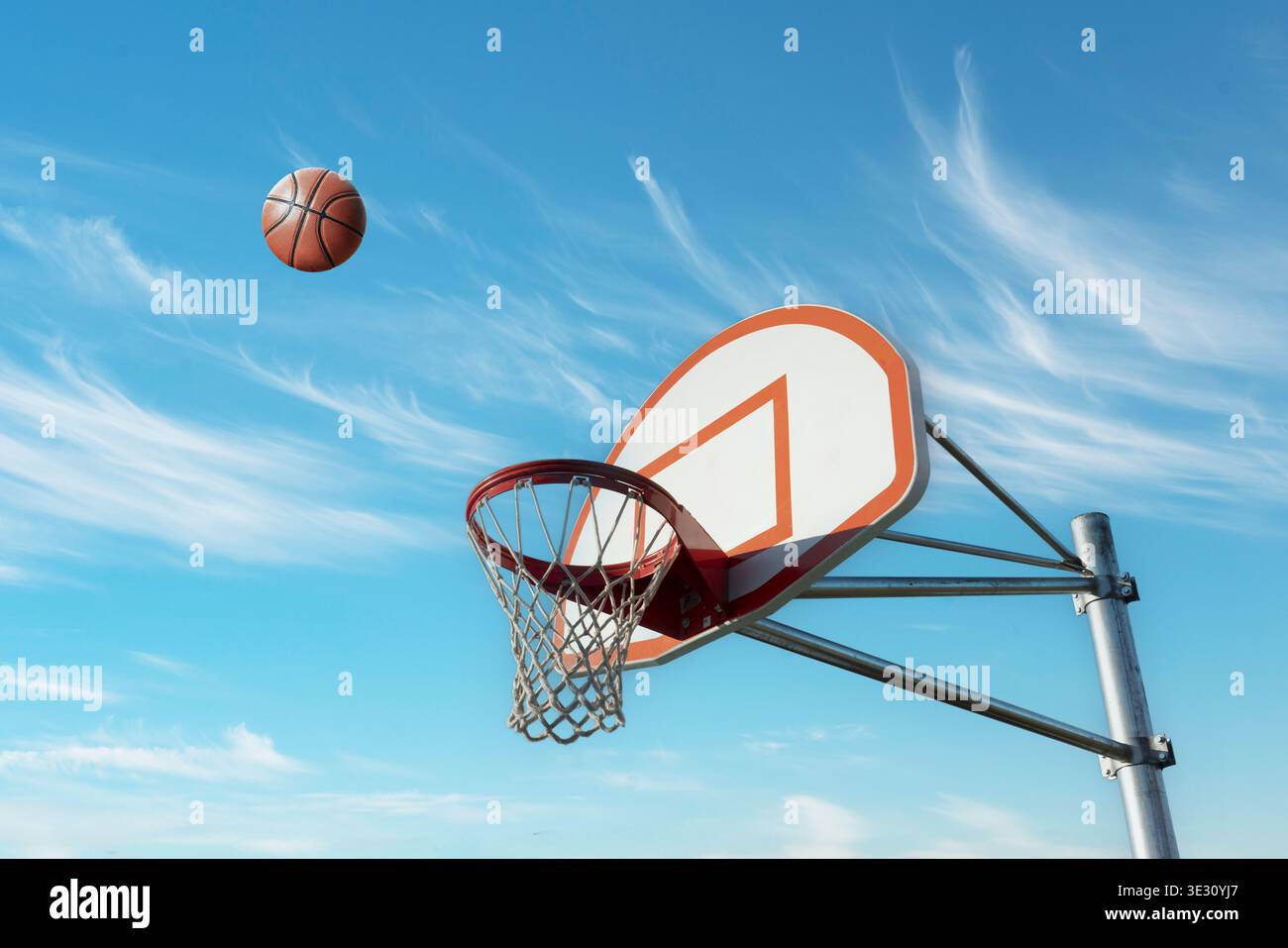Basketball nähert sich Hoop gegen Einen blauen Himmel Stockfoto