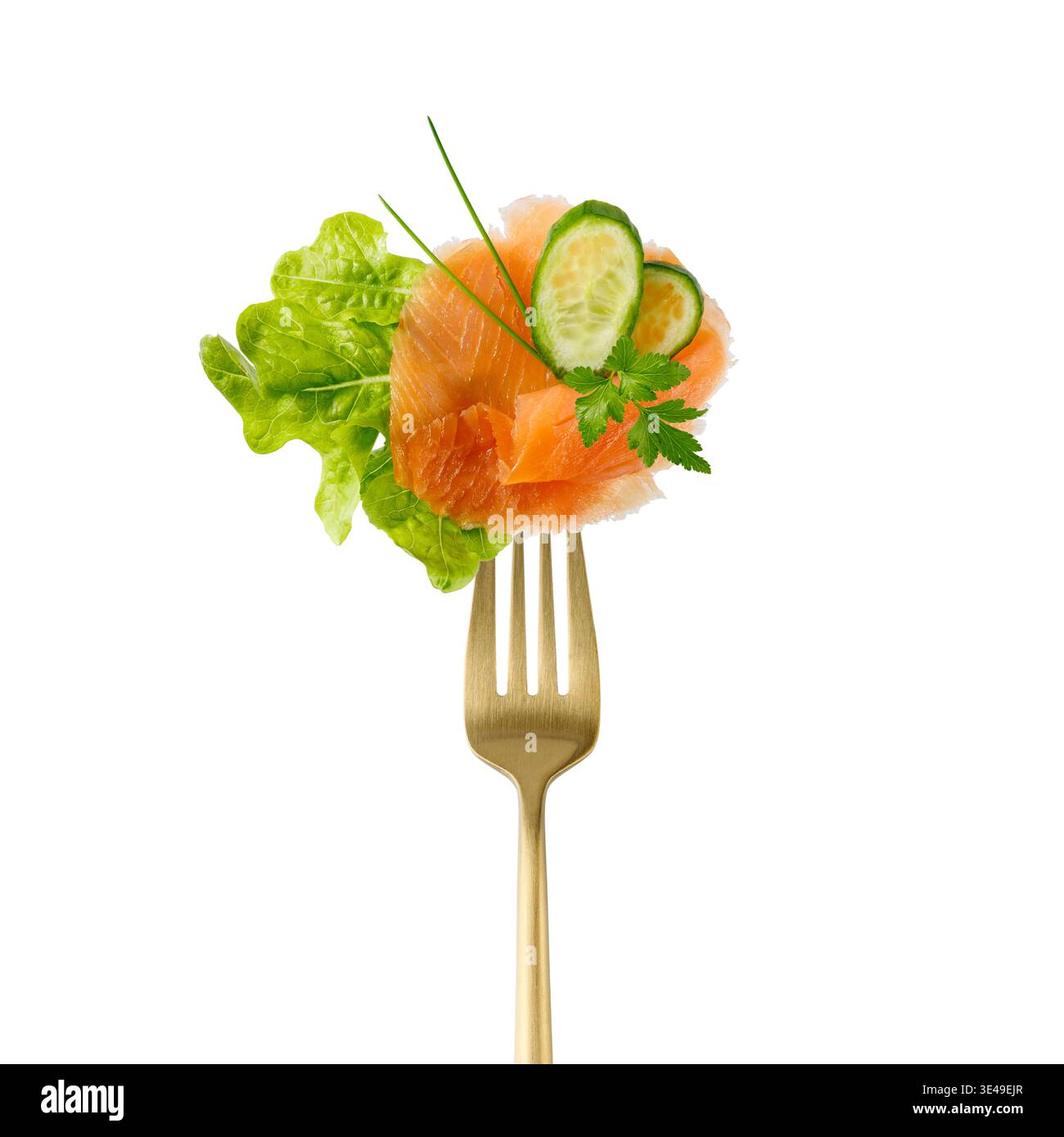 Gesalzene geräucherte rote Lachsfischscheibe, frischer Salat Salatblatt, Gurkenstücke und Kräuter auf goldener Gabel isoliert auf weißem Hintergrund. Gesunde Ernährung. Stockfoto