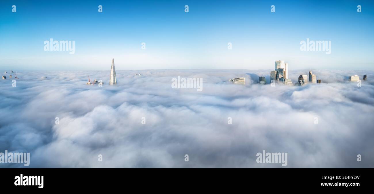 Erhöhter Panoramablick auf die Skyline von London, England, während des Nebels nur die Spitzen der Wolkenkratzer über den Wolken blicken Stockfoto