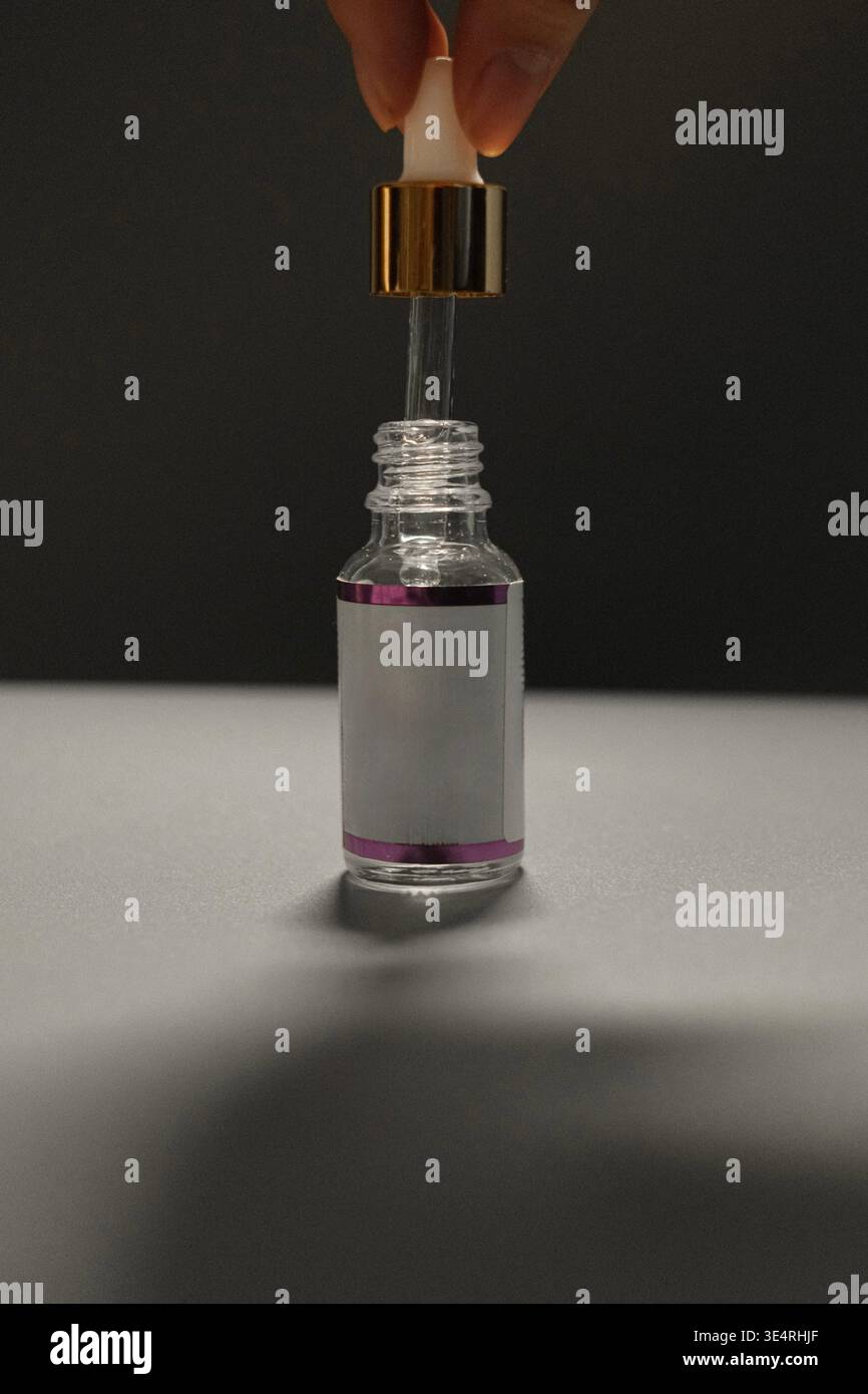 Sauberer Schuss der Hautpflegeflasche mit Tropfer auf neutralem Hintergrund. Kein Branding, ideal für Produktkonzepte. Stockfoto