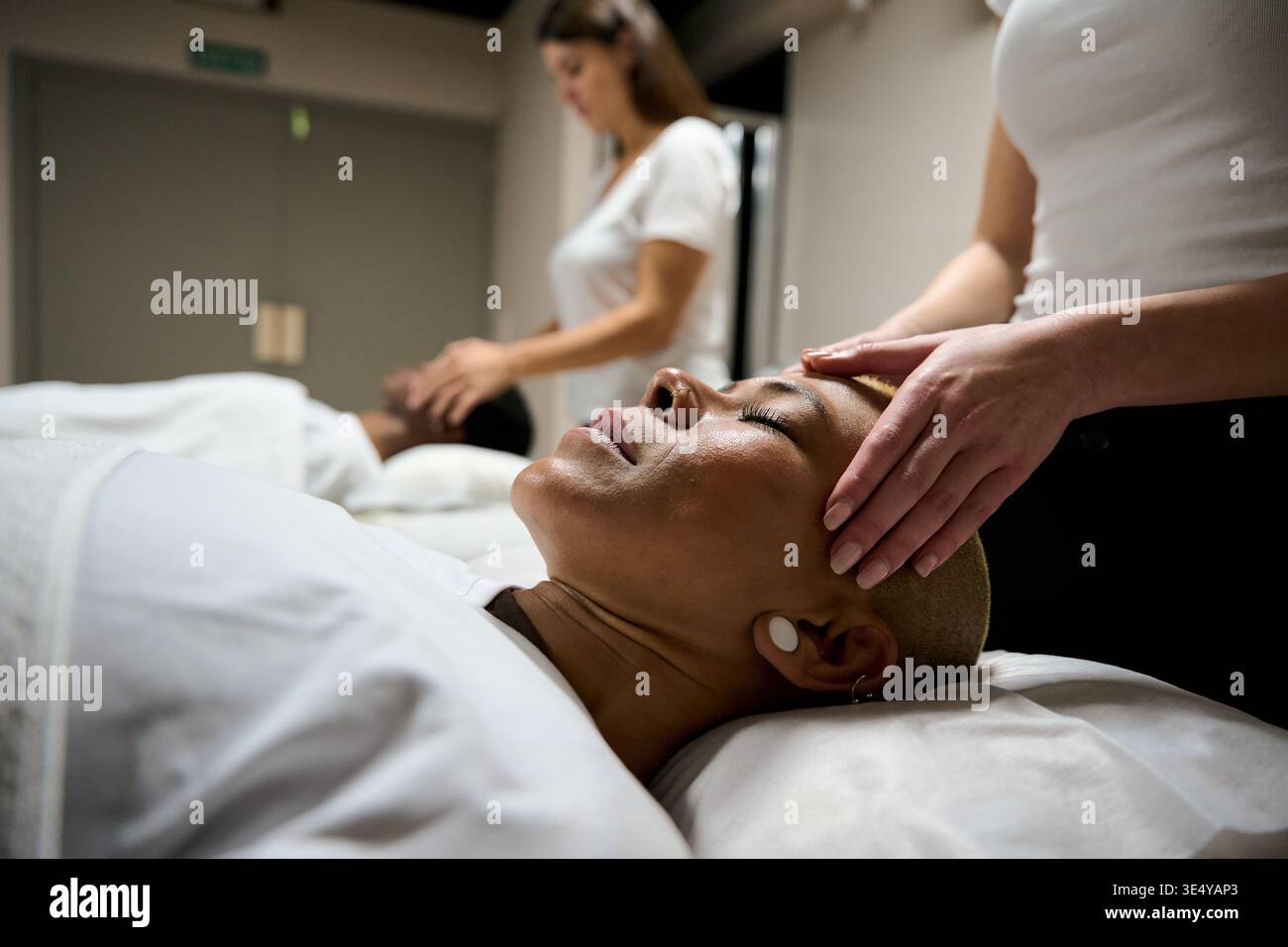 Frau erhält Kopfmassage für Entspannung und Wohlbefinden Stockfoto