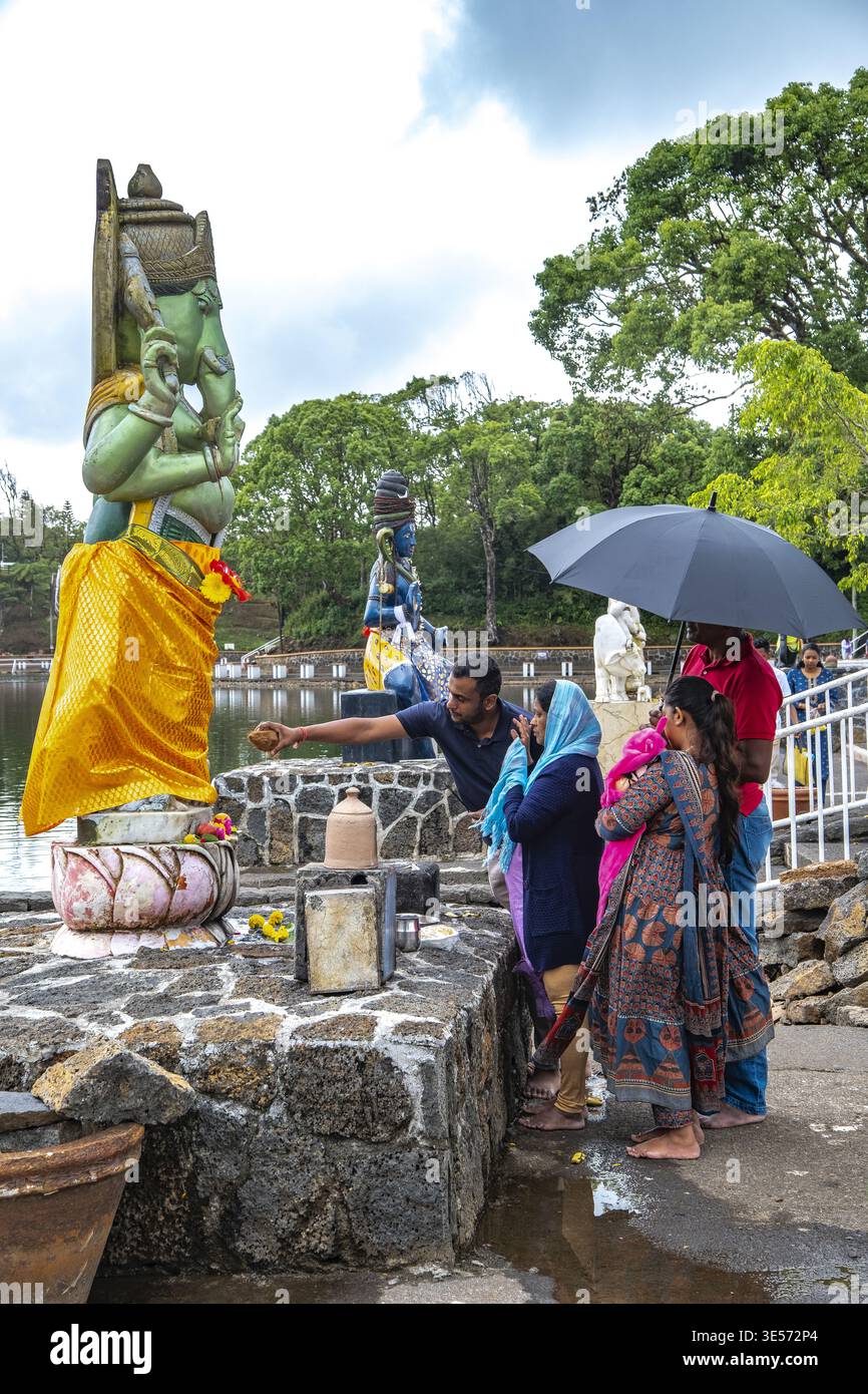 Lord Shiva hindu Tempel, Grand Bassin, Mauritius Familie betet und gibt Gott Ganesh Opfer Stockfoto