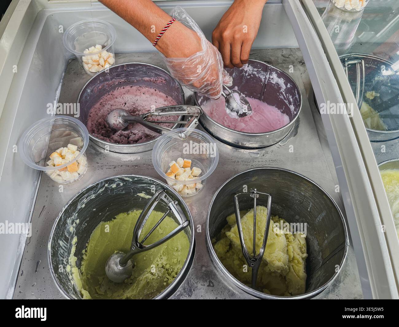 Eine Top-down-Aufnahme eines Straßenverkäufers, der „es Putar“ zubereitet, ein traditionelles indonesisches Kokos-Eis. Stockfoto