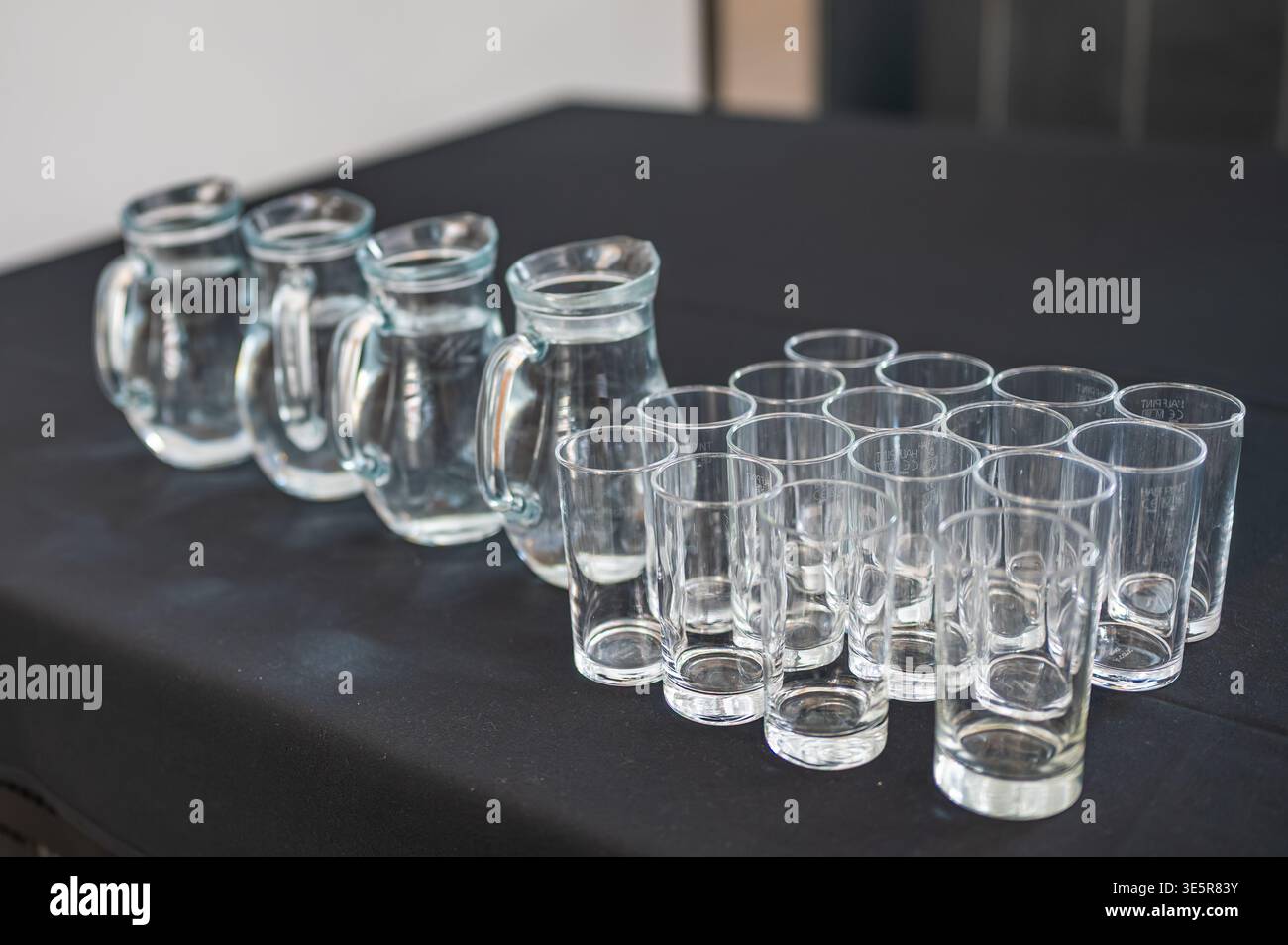 Wasserkrüge mit Gläsern Stockfoto