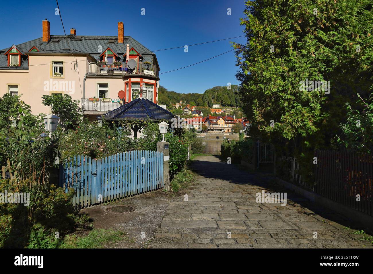 Weg vom Bahnhof zur Elbe in Stadt Wehlen: Idyllische Gasse mit Kopfsteinpflaster und Blick auf den historischen Ortskern, Sächsische Schweiz Stockfoto