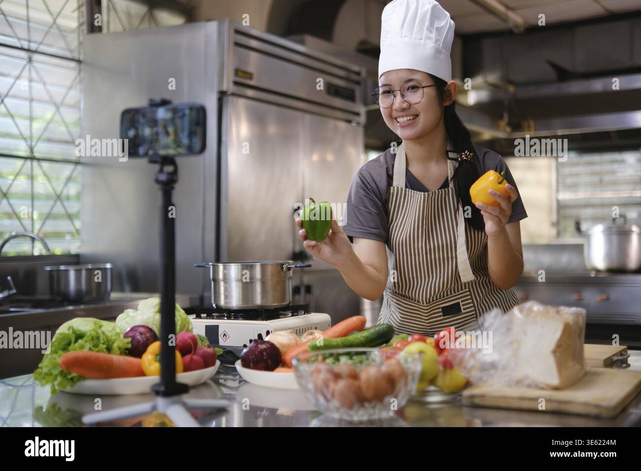 Live-Streaming beim Kochen einer Mahlzeit in der Küche mit frischen Zutaten Stockfoto